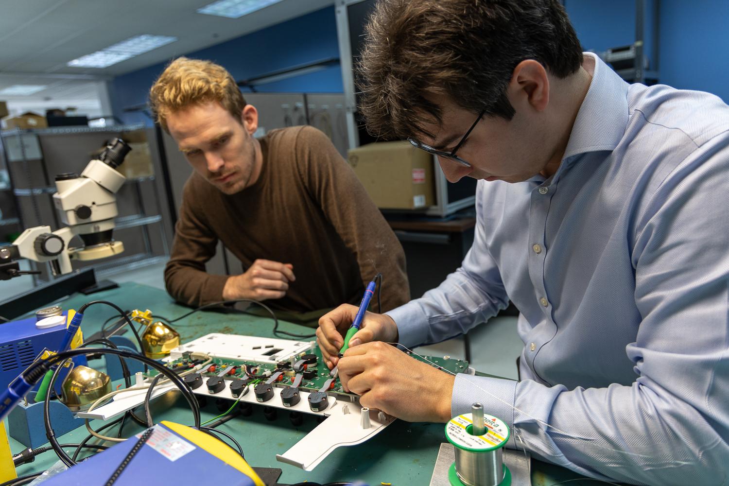 grayhill engineers working on a soldering project